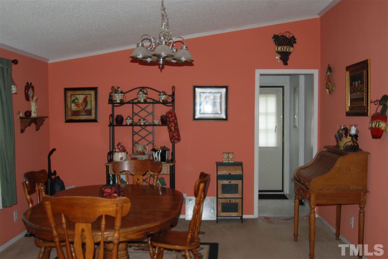 1298 O B J Road Dunn, NC 28334 - Photo 19 of 24 a view of a dining room with furniture and chandelier