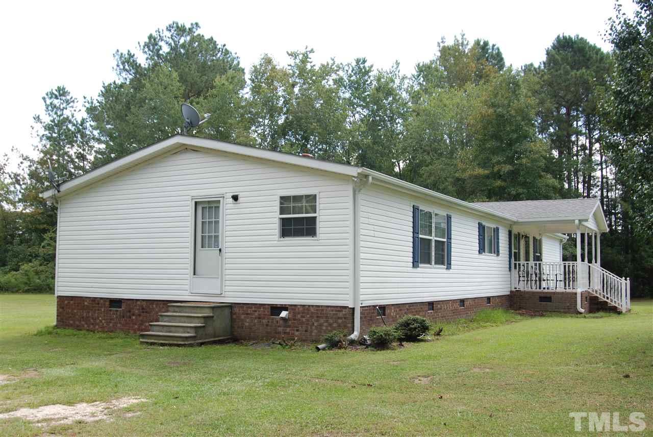 1298 O B J Road Dunn, NC 28334 - Photo 21 of 24 a view of a house with a yard