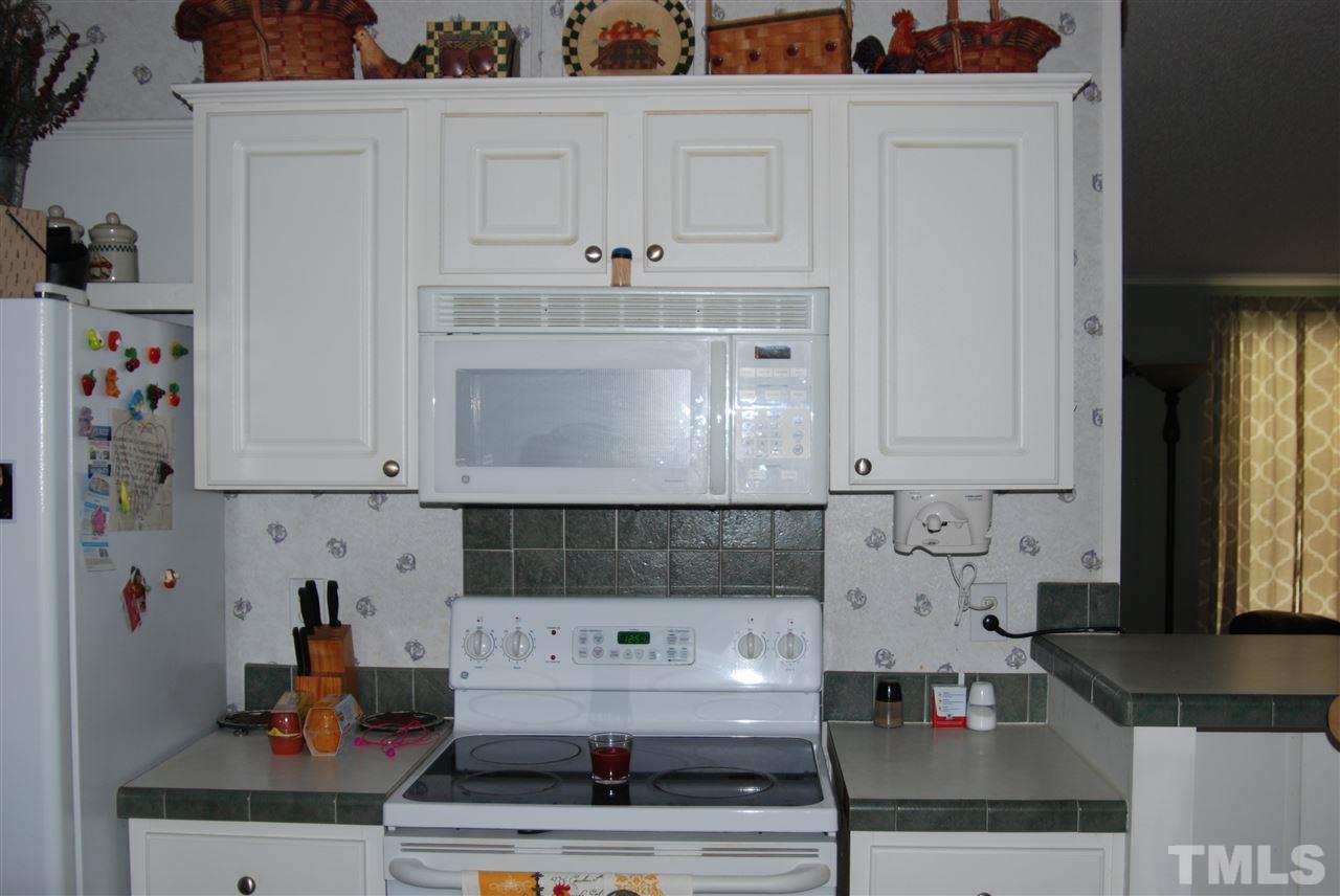 1298 O B J Road Dunn, NC 28334 - Photo 6 of 24 a kitchen with white cabinets and sink