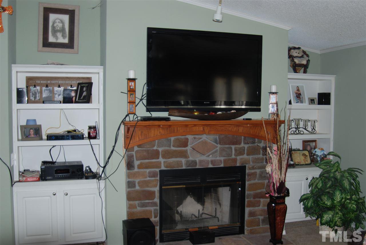 1298 O B J Road Dunn, NC 28334 - Photo 7 of 24 a room with fireplace and a flat screen tv
