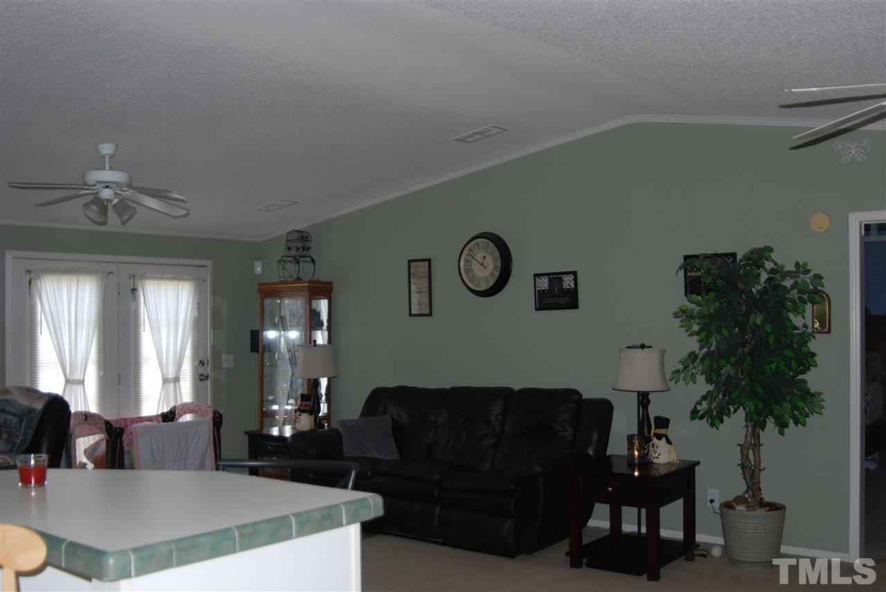 1298 O B J Road Dunn, NC 28334 - Photo 9 of 24 a living room with furniture and a chandelier