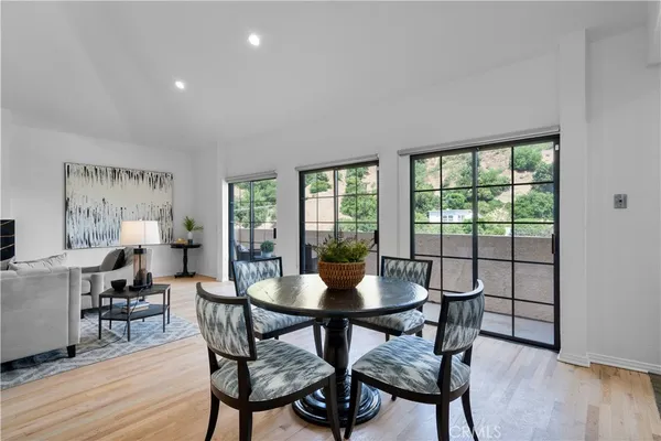 a view of a dining room with furniture window and wooden floor