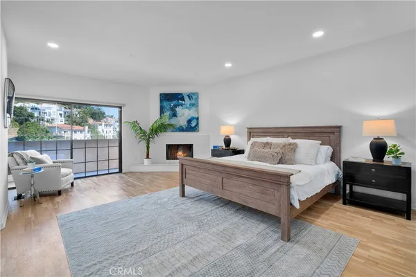 a spacious bedroom with a balcony a bed and a couch