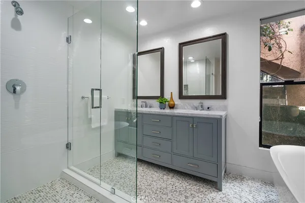 a bathroom with a shower sink and mirror
