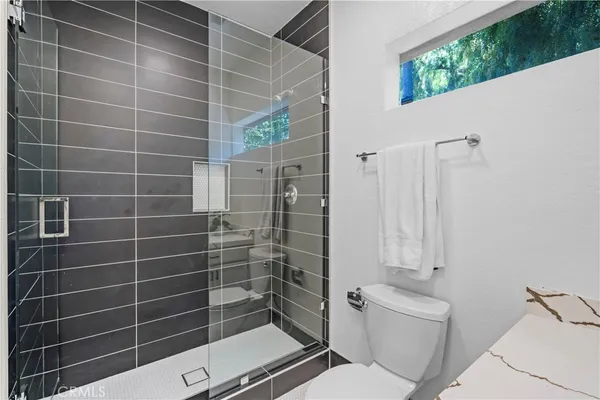 a bathroom with a toilet and a shower