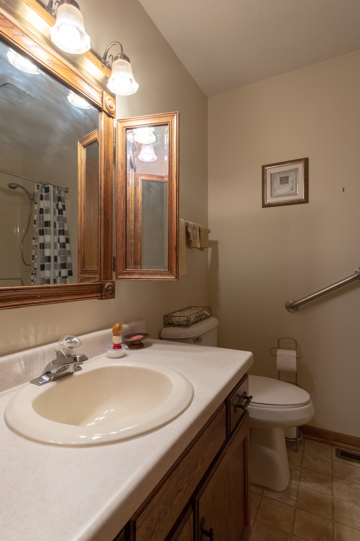 3801 Cutty Sark Road Cherry Valley, IL 61016 - Photo 17 of 25 a bathroom with a sink and a toilet