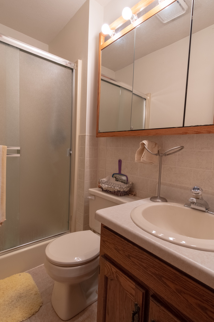 3801 Cutty Sark Road Cherry Valley, IL 61016 - Photo 20 of 25 a bathroom with a sink a toilet and shower