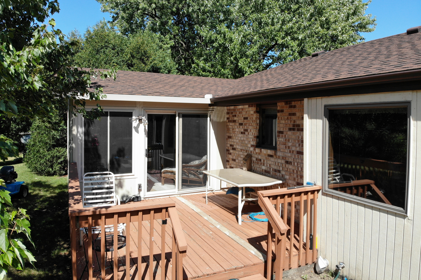 3801 Cutty Sark Road Cherry Valley, IL 61016 - Photo 24 of 25 a view of a patio with table and chairs with wooden floor and fence