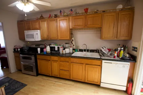 a kitchen with stainless steel appliances granite countertop a sink stove and cabinets