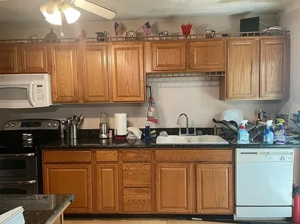 a kitchen with stainless steel appliances granite countertop a sink dishwasher and cabinets with wooden floor
