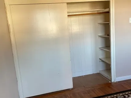 a view of a room with wooden floor