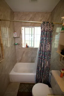 a bathroom with a bathtub and shower