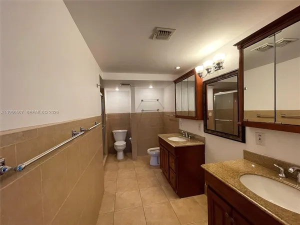 a bathroom with a sink a toilet and mirror