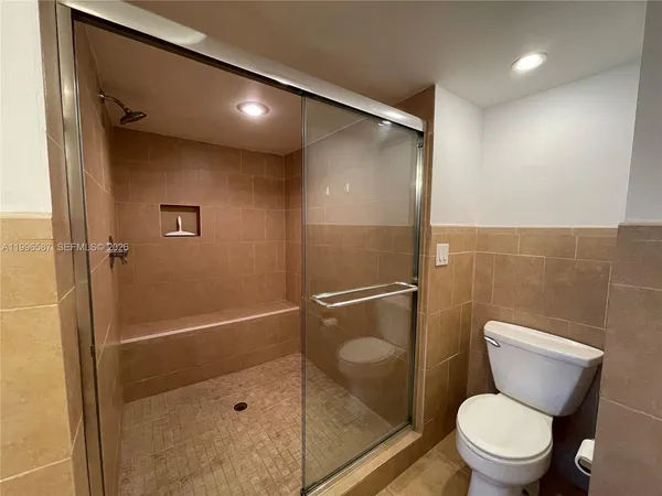 a bathroom with a toilet and a shower