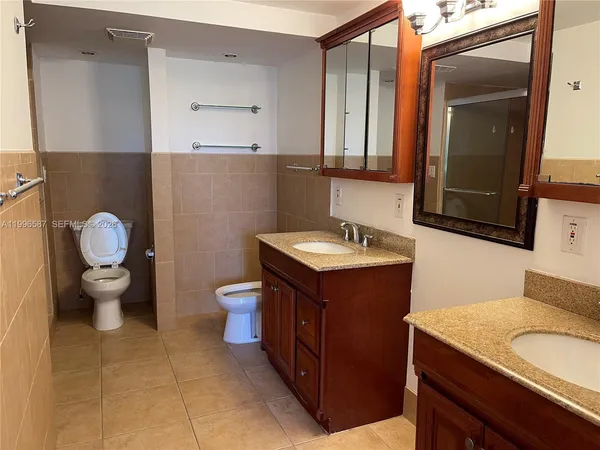 a bathroom with a toilet sink and mirror