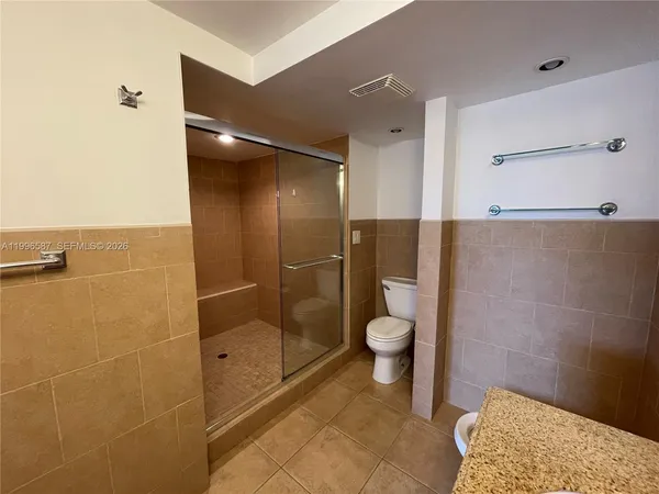 a bathroom with a shower and a toilet