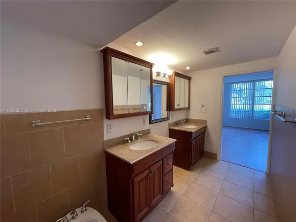 a bathroom with a sink a washer and dryer