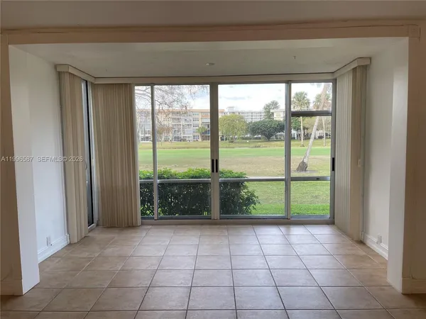 a view of empty room with large windows