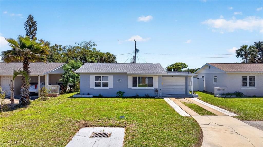 47 Carol Road Ormond Beach, FL 32176 - Photo 50 of 54 a front view of house with yard and green space