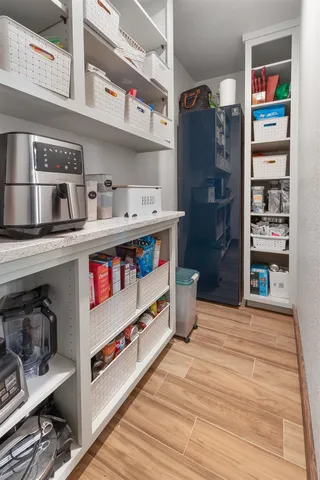 a kitchen with a refrigerator and cabinets