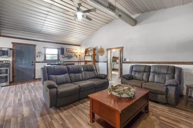 a bedroom with a bed and a ceiling fan