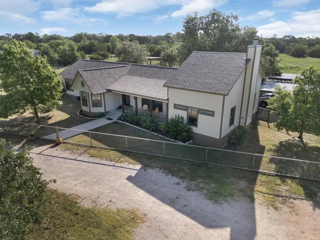 a view of a swimming pool with a patio and a yard