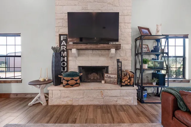a dining room with furniture a chandelier and wooden floor