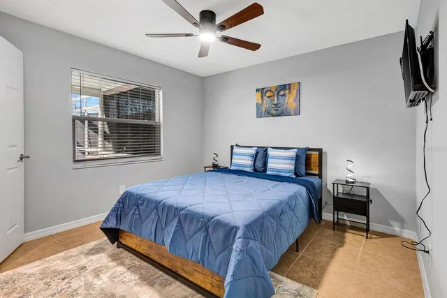 a living room with a bed furniture and a flat screen tv