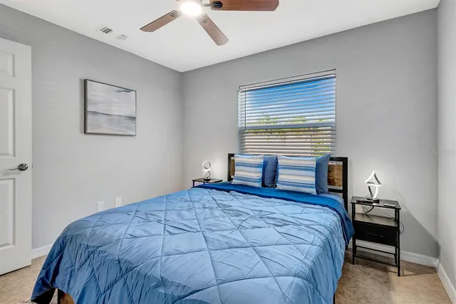 a bedroom with a bed and a chandelier