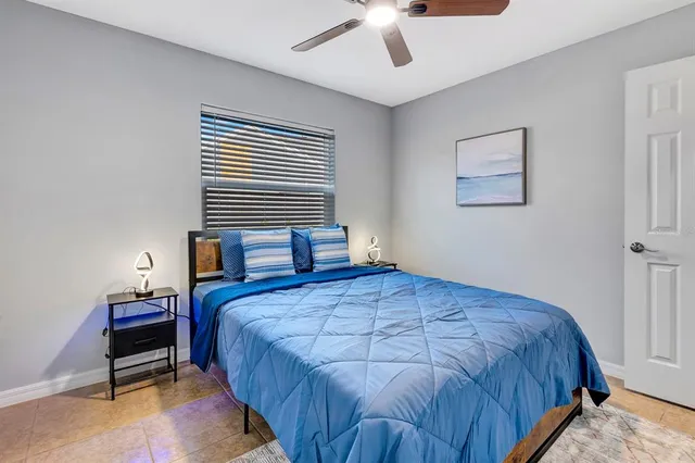 a bedroom with a bed wall painting and a window
