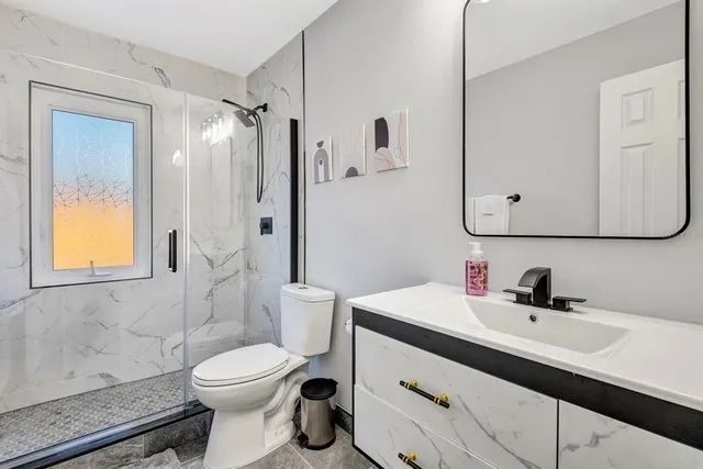 a bathroom with a sink toilet and shower