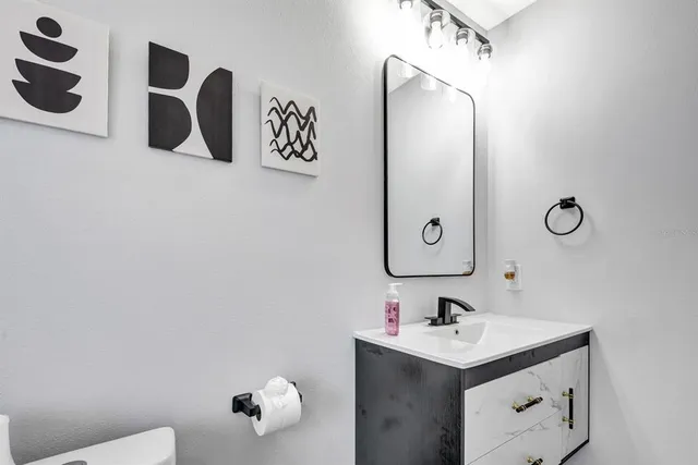 a bathroom with a sink vanity and mirror
