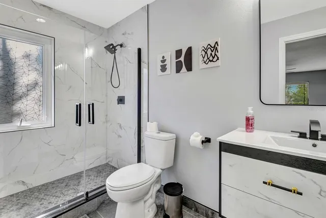 a bathroom with a sink toilet and shower