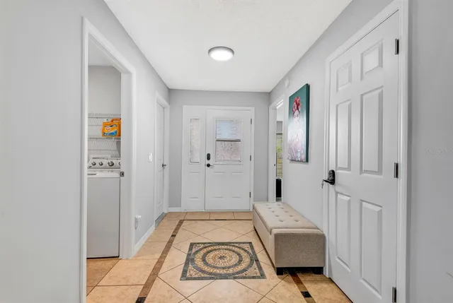 a view of a hallway with entryway wooden floor and windows