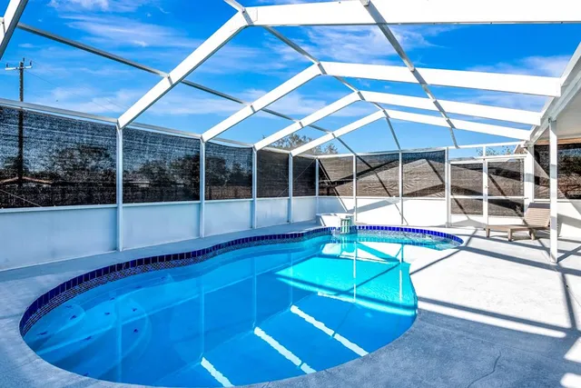a room with pool table and windows