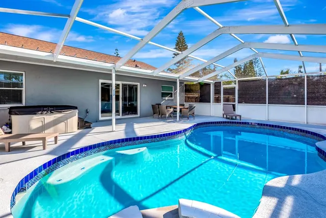 a swimming pool with outdoor seating and yard