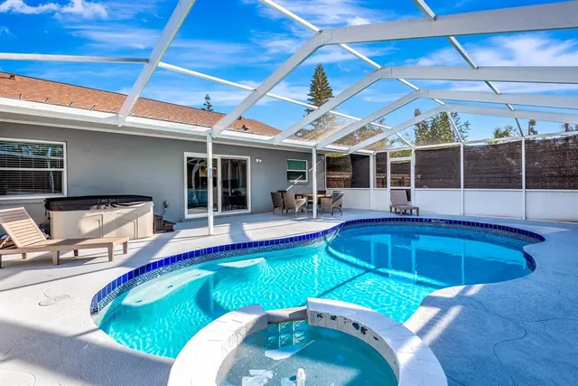 a view of a swimming pool with seating area
