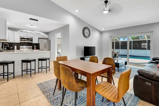 a view of a dining room with furniture and a large window