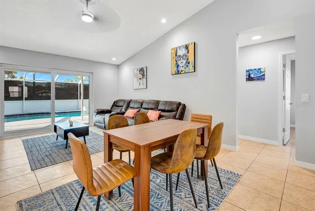 a view of a dining room with furniture and chandelier