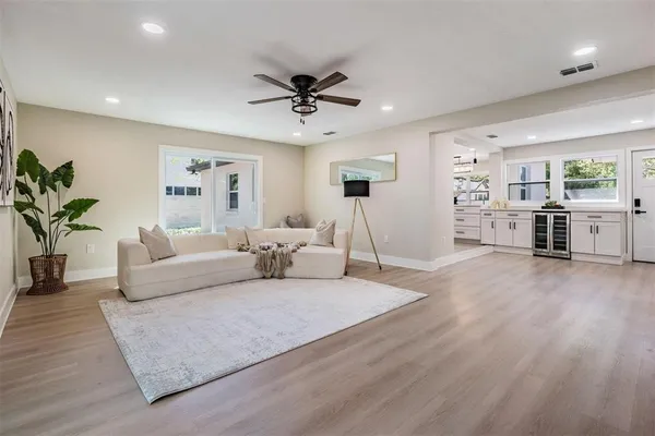a living room with furniture and a wooden floor