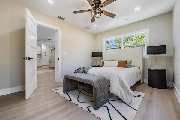 a bedroom with a bed and a chandelier