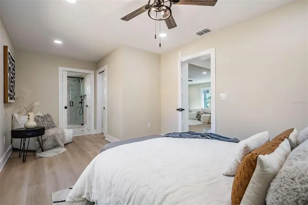 a bedroom with a bed and a chandelier