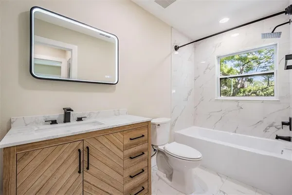 a bathroom with a sink a toilet and a bathtub