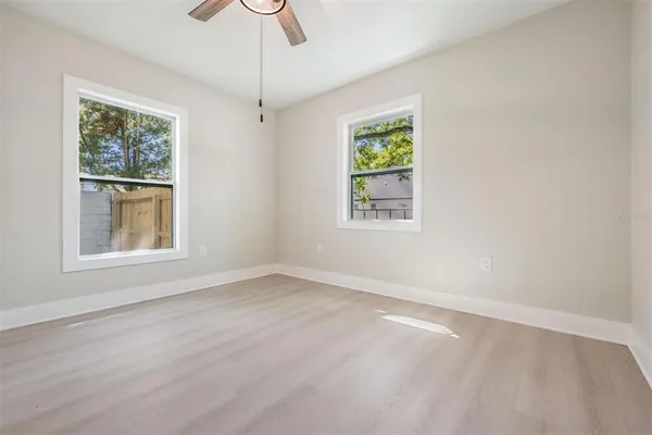 an empty room with windows and closet
