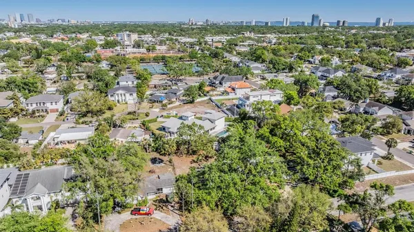 an aerial view of residential houses with city view