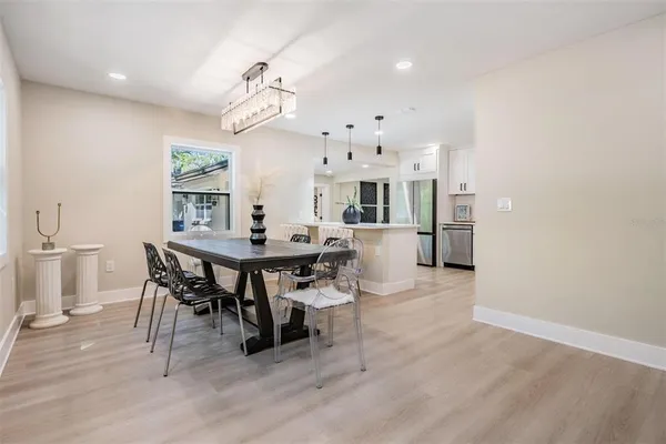 a view of a dining room with furniture and a chandelier