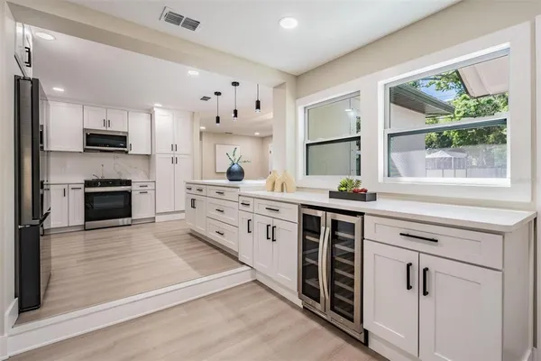 a kitchen with stainless steel appliances a stove sink and cabinets