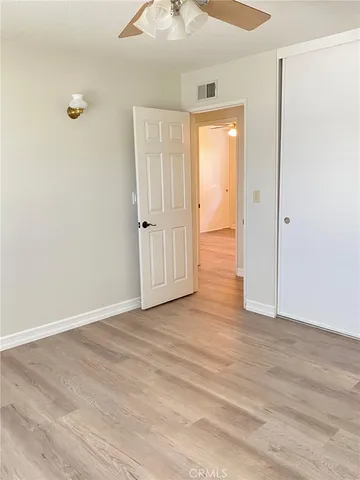 a view of an empty room and wooden floor