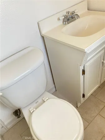 a bathroom with a sink a mirror a toilet and shower