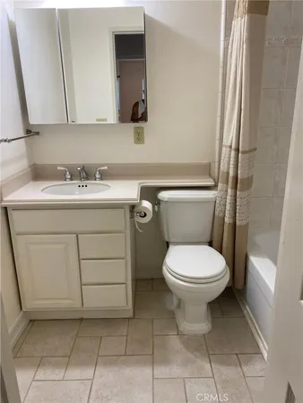 a view of a small space with wooden floor and fan